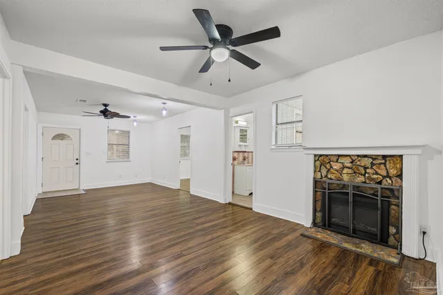 a view of an empty room and wooden floor