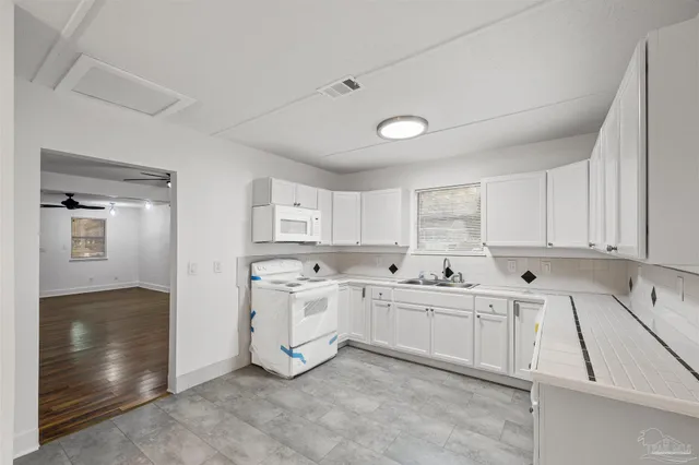 a view of empty room with cabinet and window