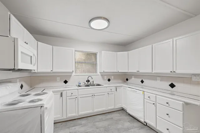 a view of white cabinets and sink