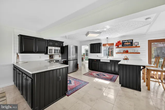 a living room with furniture kitchen view and a couch
