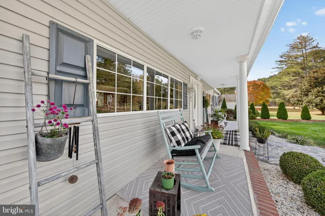 a kitchen with stainless steel appliances kitchen island granite countertop a refrigerator and cabinets
