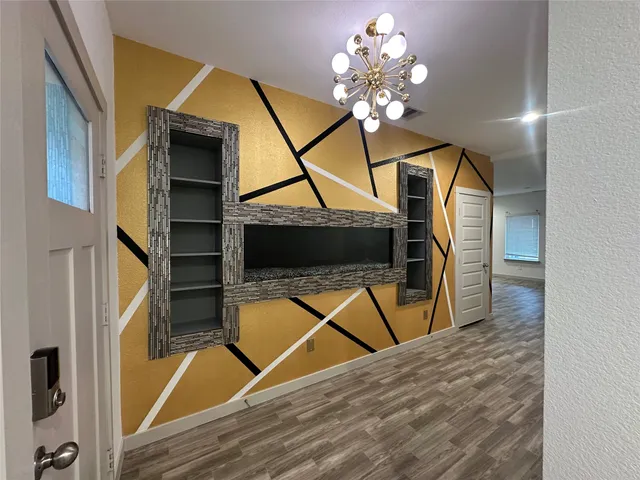 a large white kitchen with kitchen island a sink dishwasher a stove and a refrigerator with wooden floor