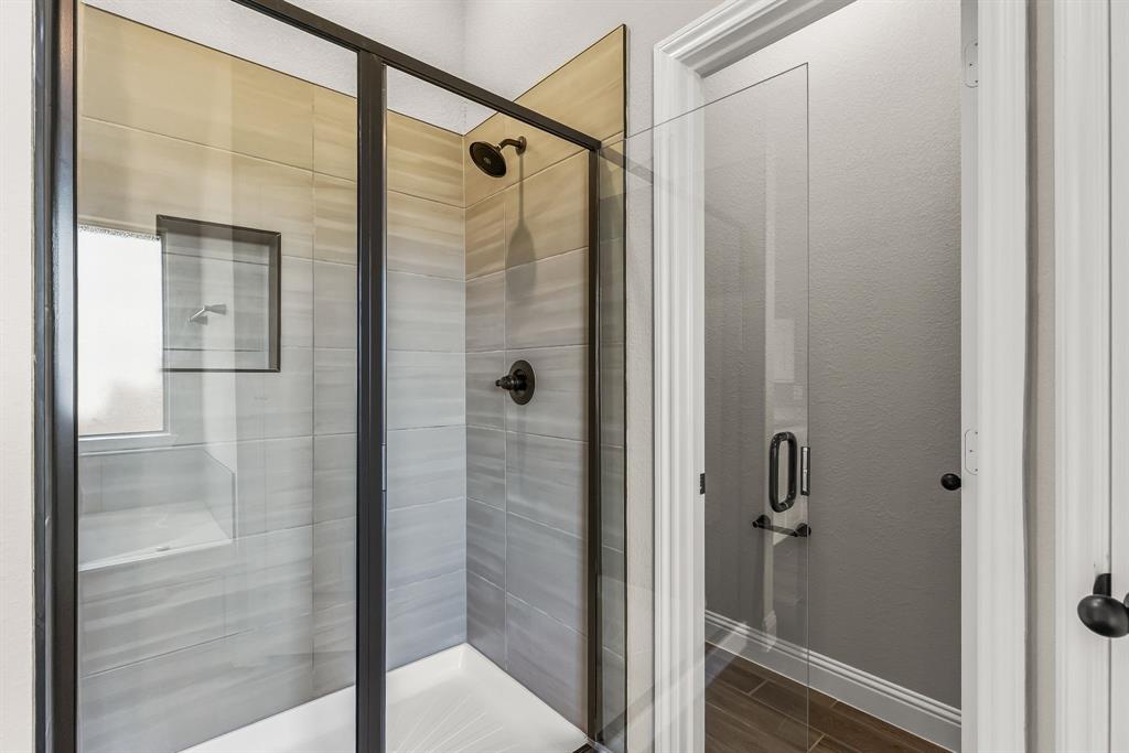 314 Pennington Road Josephine, TX 75173 - Photo 17 of 37 a bathroom with a glass shower door
