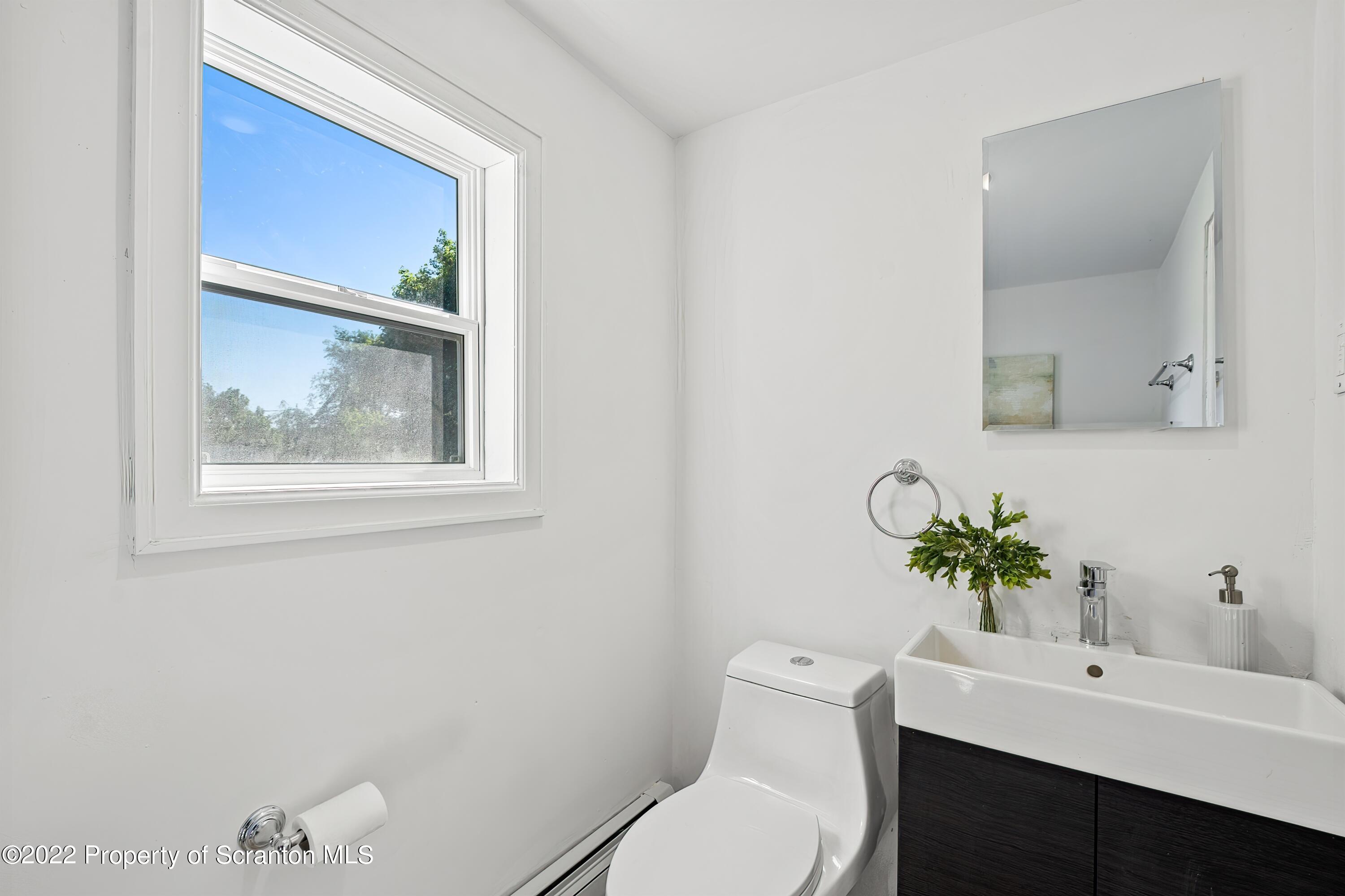 533 Cherry Street Scranton, PA 18505 - Photo 21 of 33 a white toilet sitting next to a bathroom sink