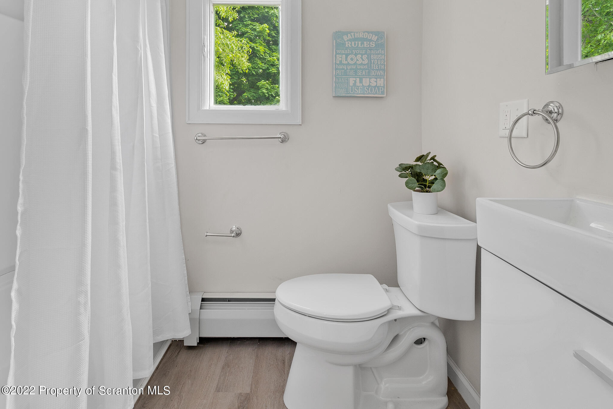 533 Cherry Street Scranton, PA 18505 - Photo 25 of 33 a bathroom with a toilet and a shower curtain