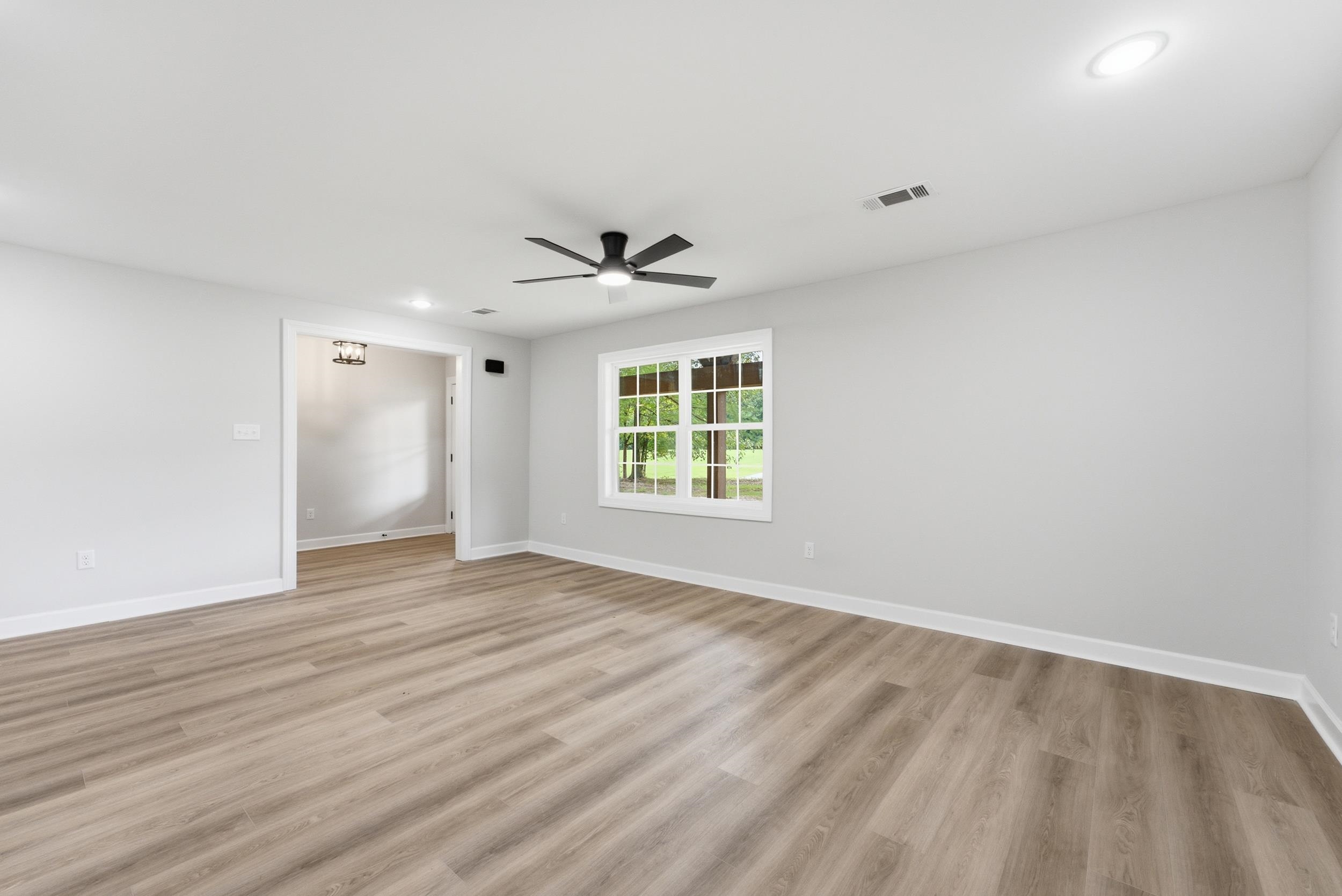 4683 Belmont Road Hernando, MS 38632 - Photo 10 of 21 Spacious interior featuring wood-finish flooring, white baseboards, and light gray walls