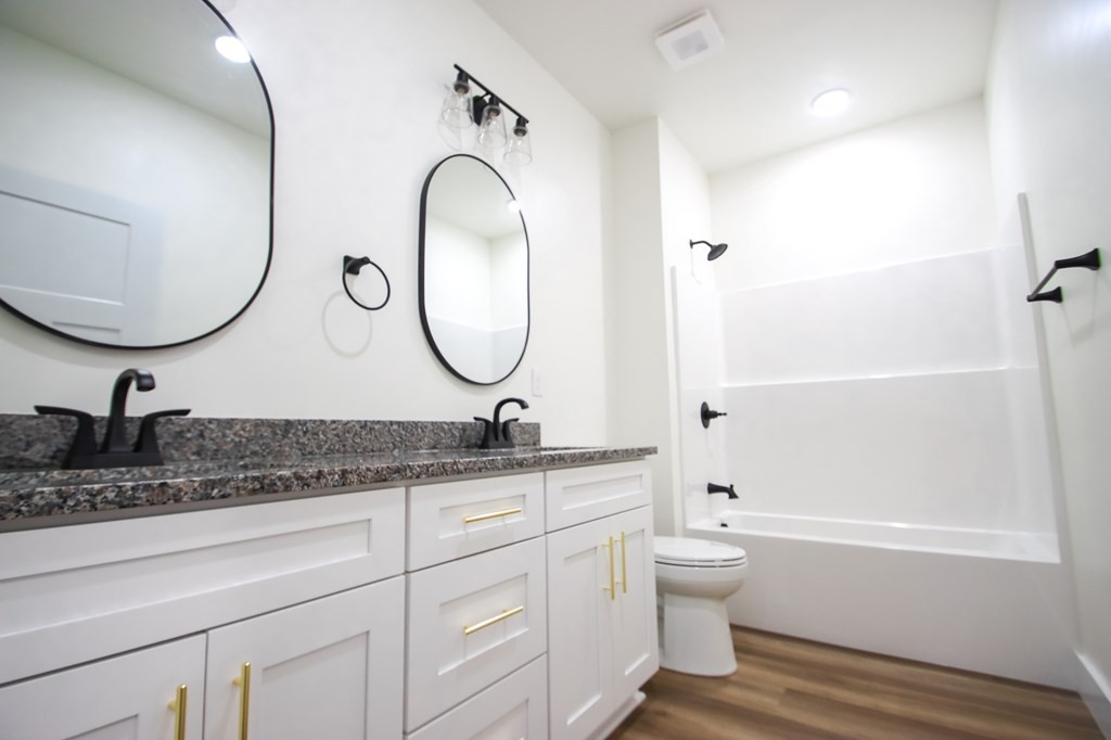 329 Webb Drive Sparta, TN 38583 - Photo 14 of 17 a bathroom with a granite countertop toilet a sink and a mirror