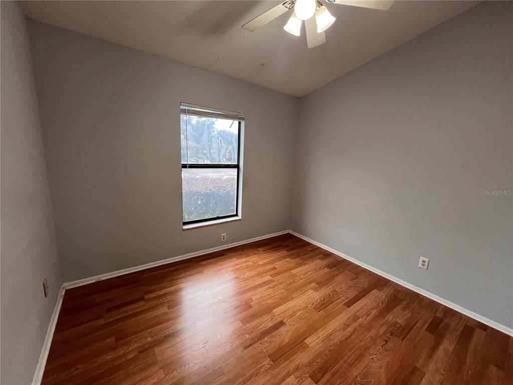 7771 Country Place, Unit 7 Winter Park, FL 32792 - Photo 13 of 15 a view of an empty room with wooden floor and a window