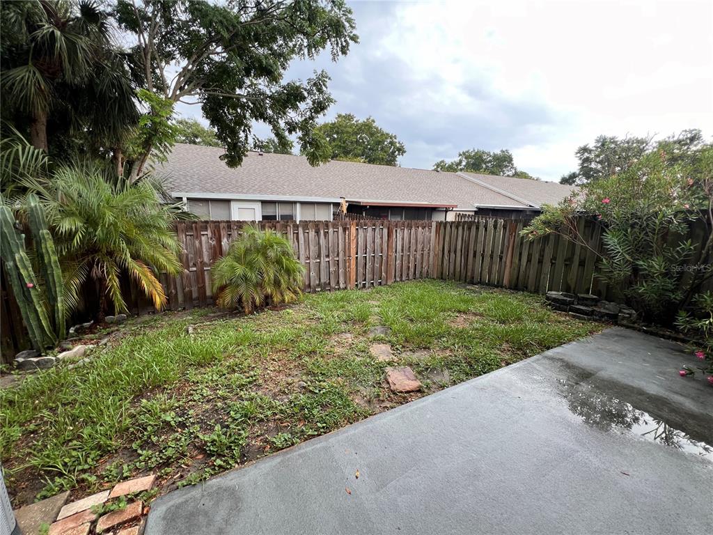 7771 Country Place, Unit 7 Winter Park, FL 32792 - Photo 15 of 15 a view of a garden with plants and large trees