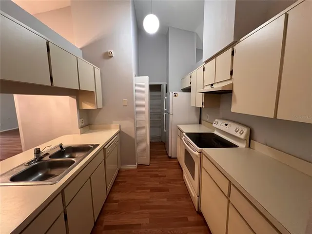 a kitchen with stainless steel appliances a sink dishwasher stove and refrigerator