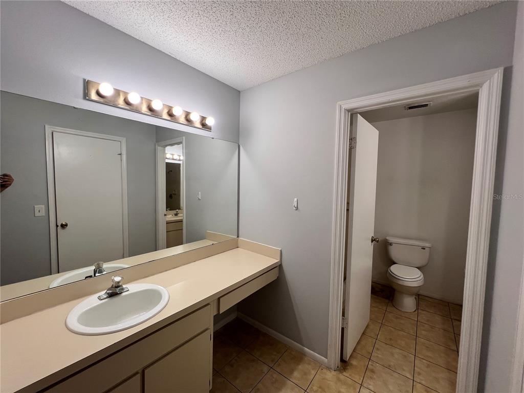 7771 Country Place, Unit 7 Winter Park, FL 32792 - Photo 7 of 15 a bathroom with a sink a toilet and a mirror