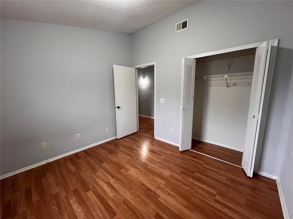 7771 Country Place, Unit 7 Winter Park, FL 32792 - Photo 10 of 15 a view of an empty room with wooden floor and a mirror