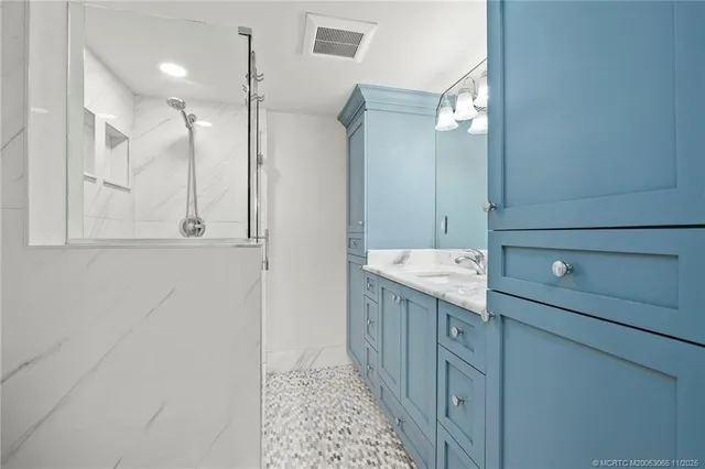 a bathroom with a mirror and a shower