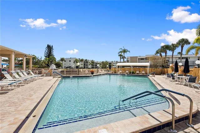 a view of a chairs and table in a backyard