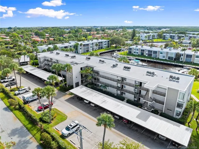 a view of a patio with dining table and chairs with a barbeque grill and plants