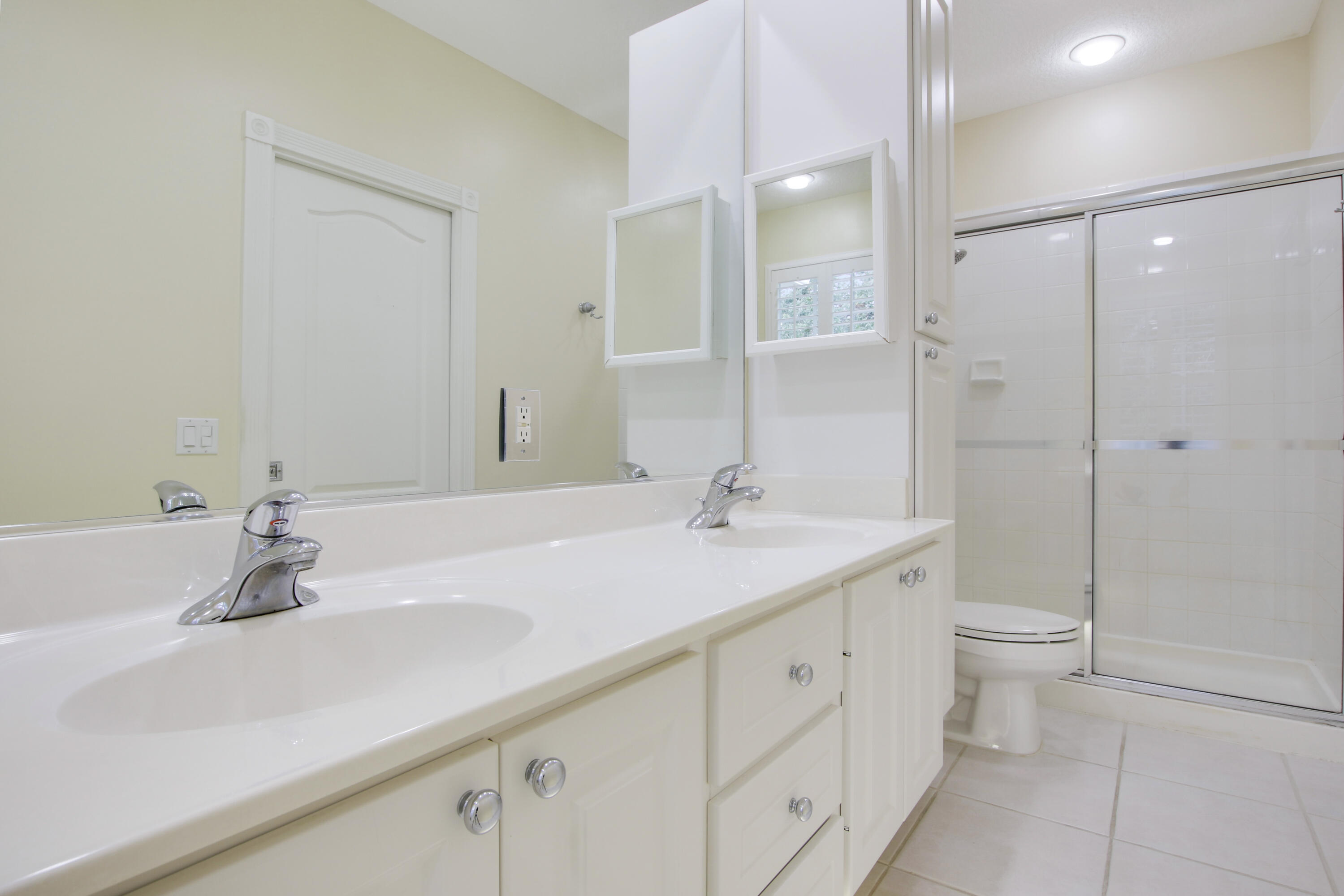 153 Andover Drive Jupiter, FL 33458 - Photo 16 of 25 a bathroom with a sink a toilet and shower