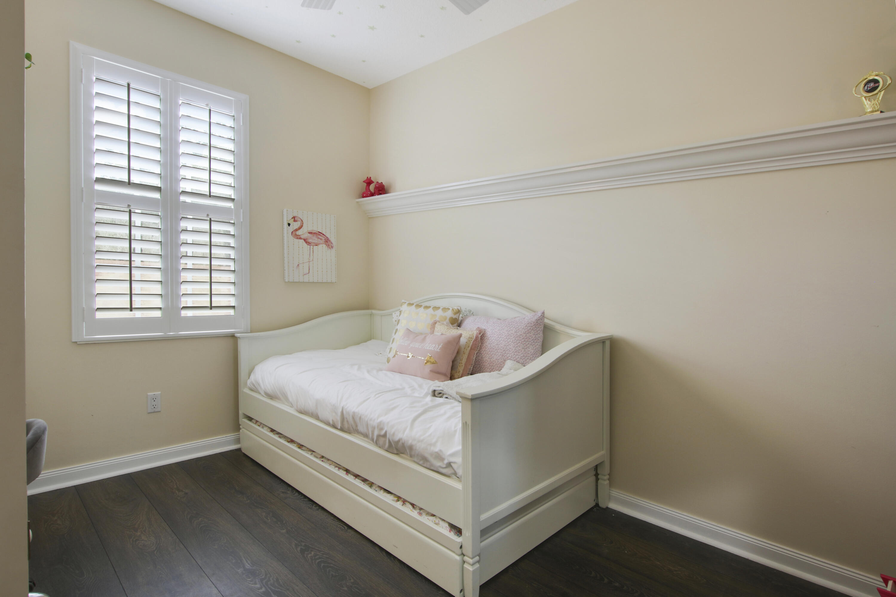 153 Andover Drive Jupiter, FL 33458 - Photo 19 of 25 a bed sitting in a bedroom next to a window