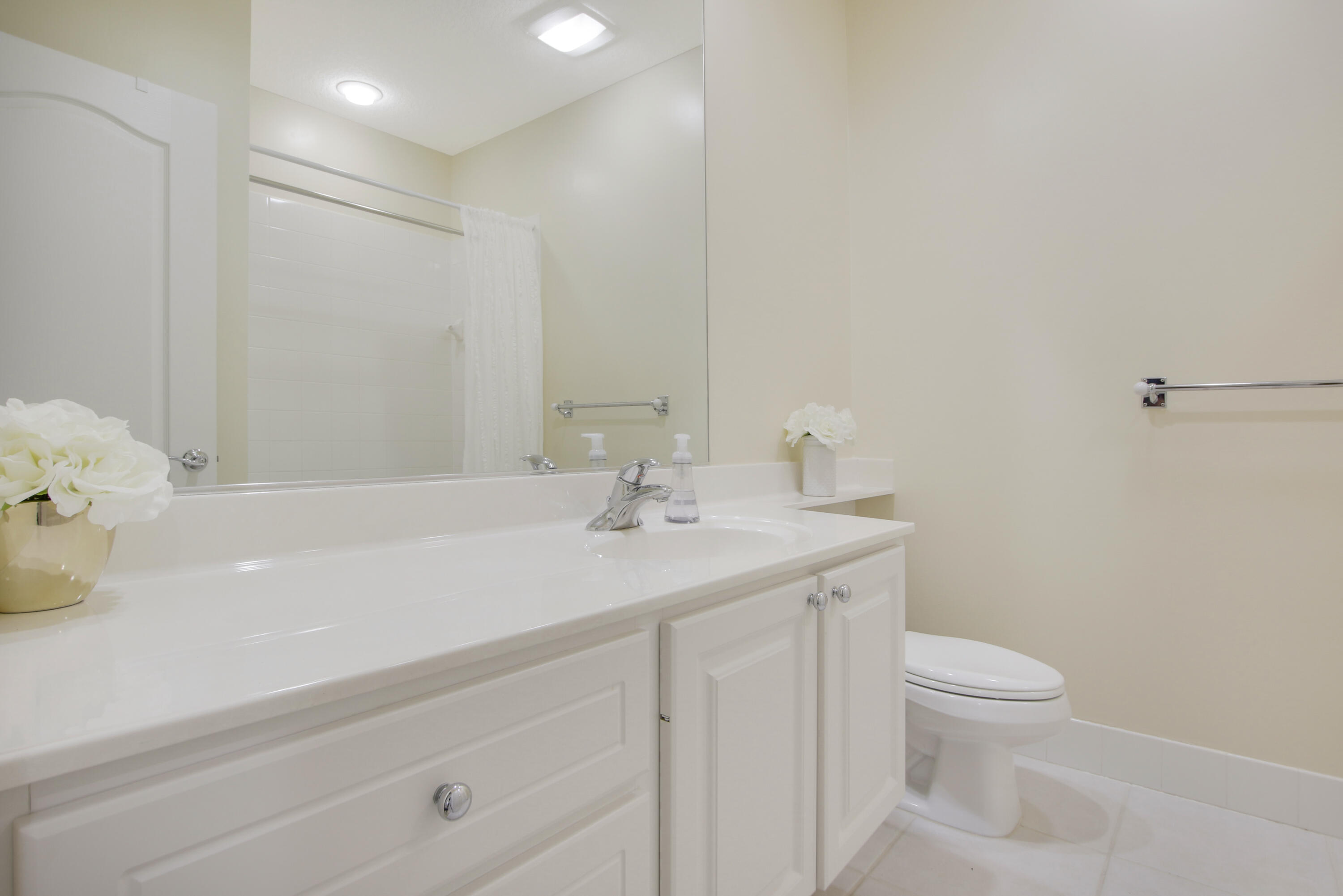 153 Andover Drive Jupiter, FL 33458 - Photo 20 of 25 a bathroom with a sink a toilet and a mirror