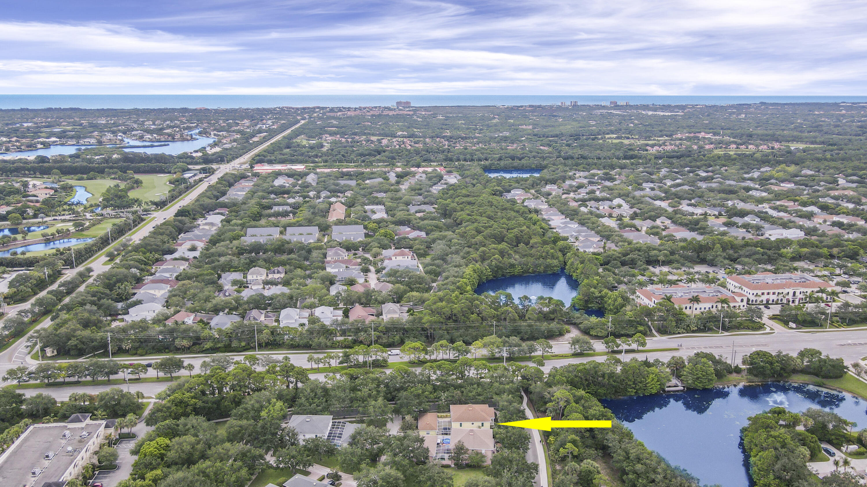 153 Andover Drive Jupiter, FL 33458 - Photo 4 of 25 an aerial view of a city with lots of residential buildings lake and ocean view