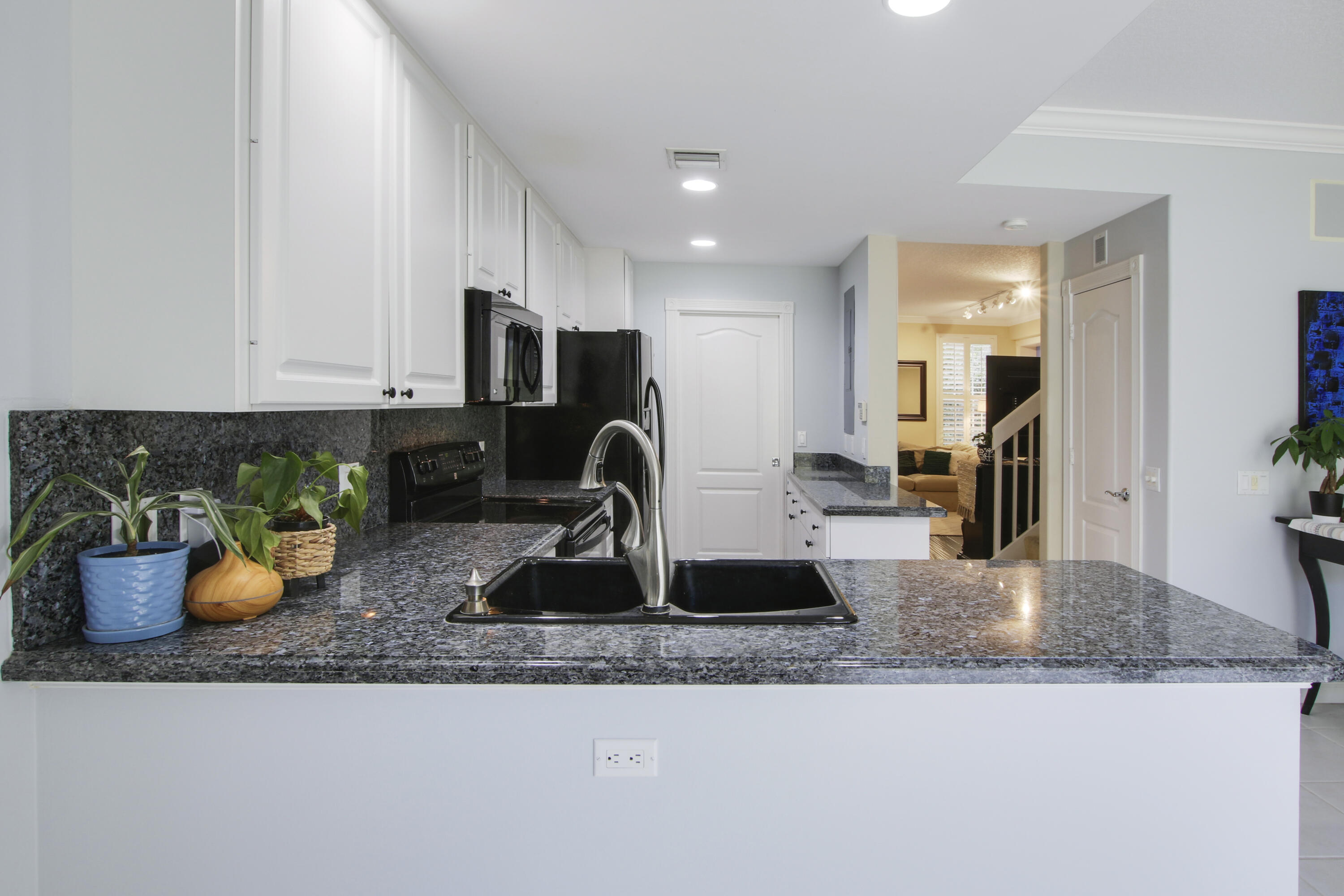 153 Andover Drive Jupiter, FL 33458 - Photo 9 of 25 a kitchen with a sink a stove and cabinets