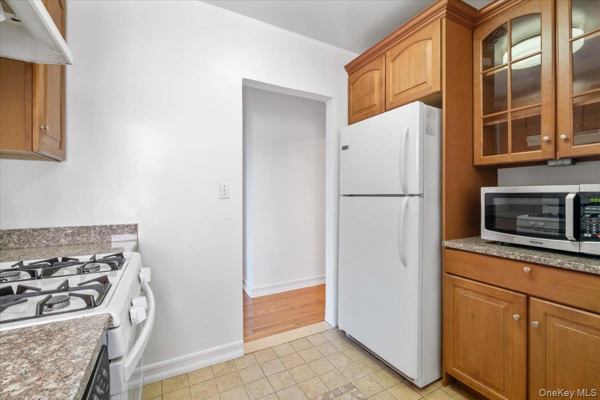 142 Garth Road, Unit 5K Scarsdale, NY 10583 - Photo 12 of 33 Galley kitchen has cabinets on both sides of room