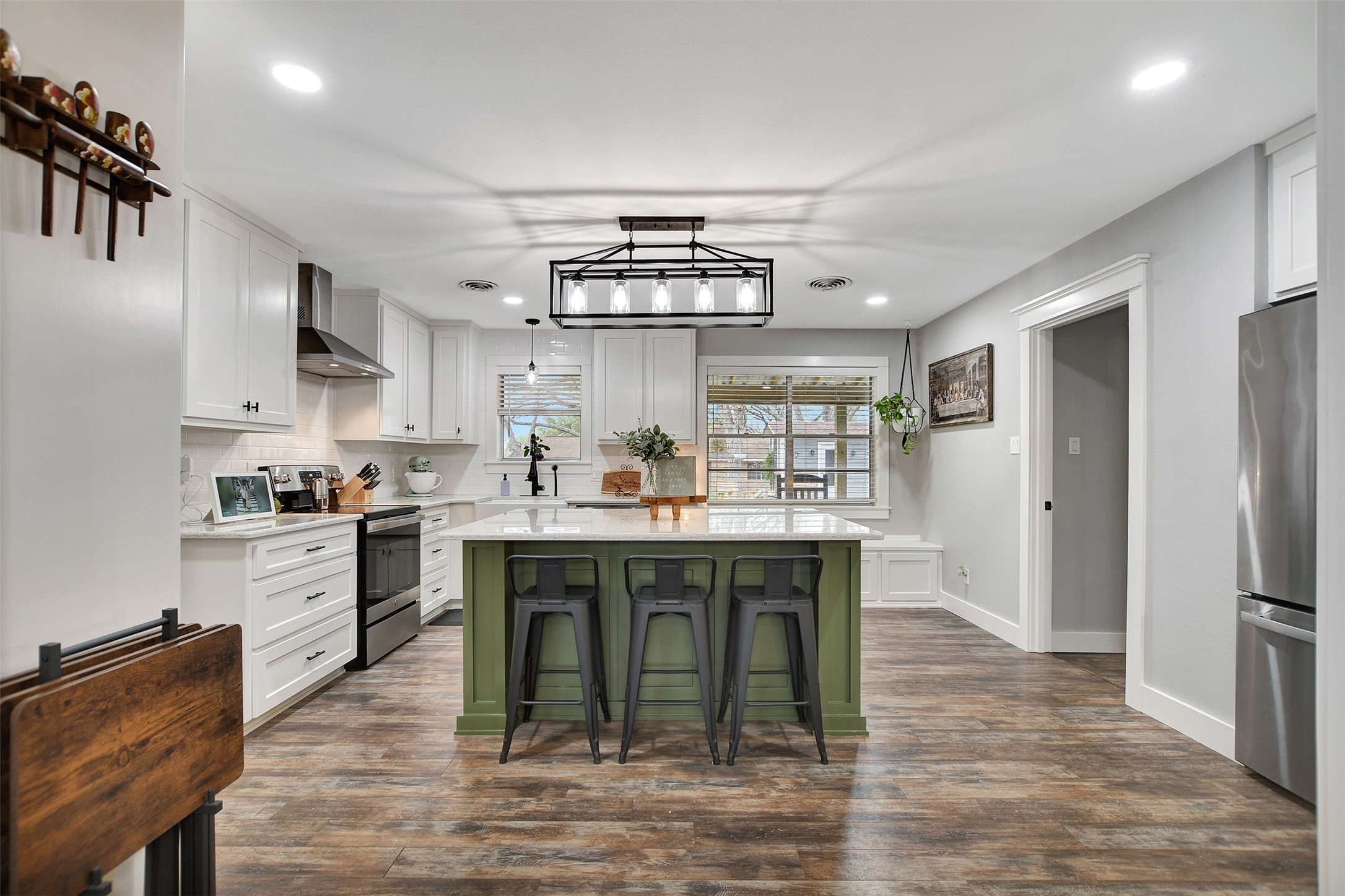 205 Munz Street Brenham, TX 77833 - Photo 12 of 48 a kitchen with stainless steel appliances granite countertop a stove top oven a refrigerator a sink and dishwasher with wooden floor