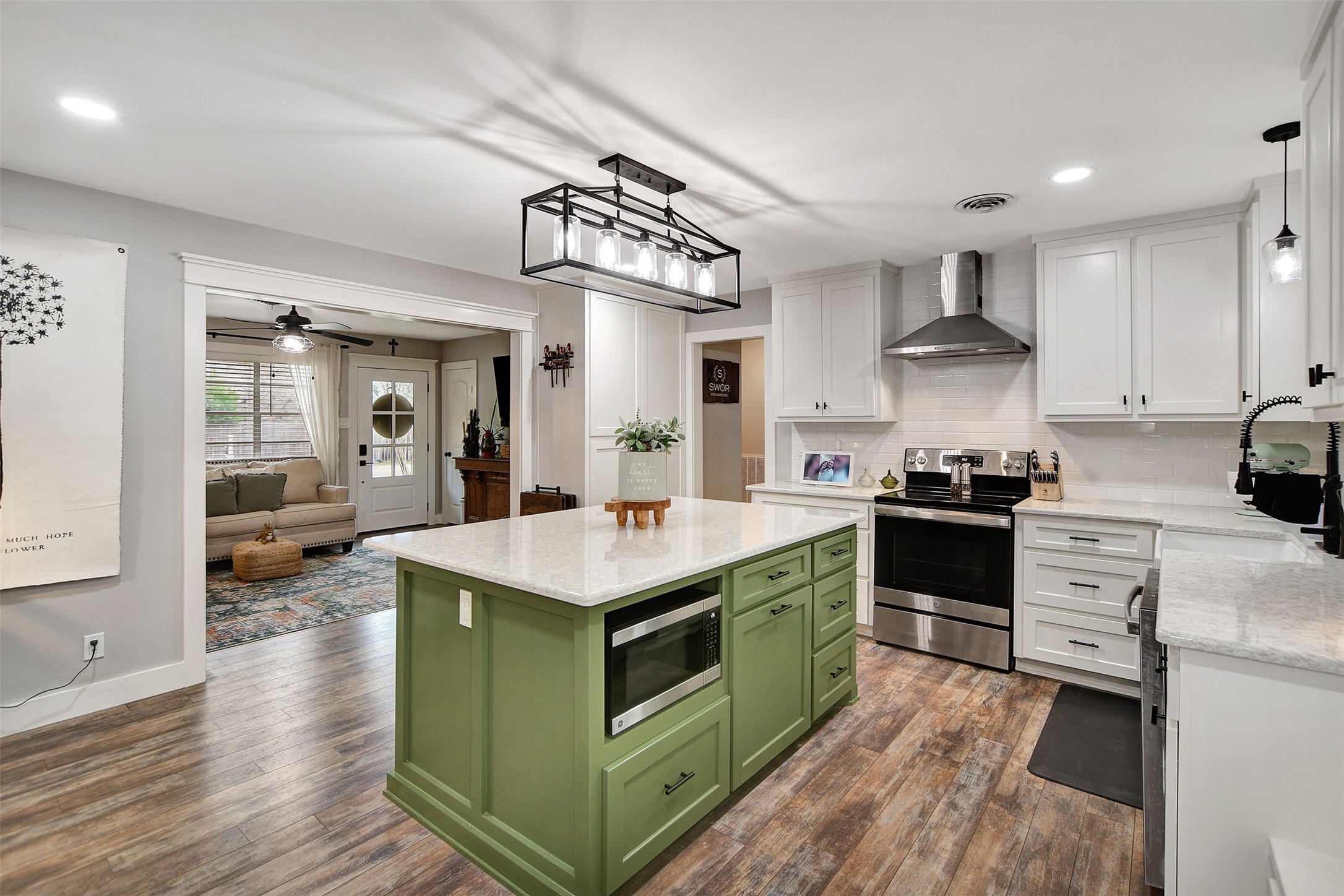 205 Munz Street Brenham, TX 77833 - Photo 15 of 48 a kitchen with stainless steel appliances granite countertop a stove and a sink