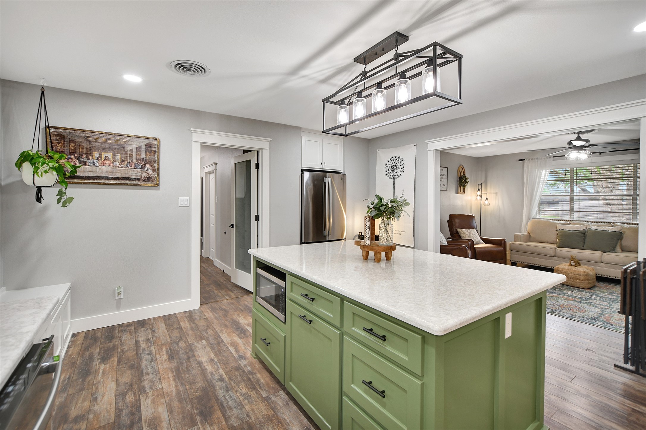 205 Munz Street Brenham, TX 77833 - Photo 16 of 48 a view of kitchen island a sink wooden floor dining table and chairs