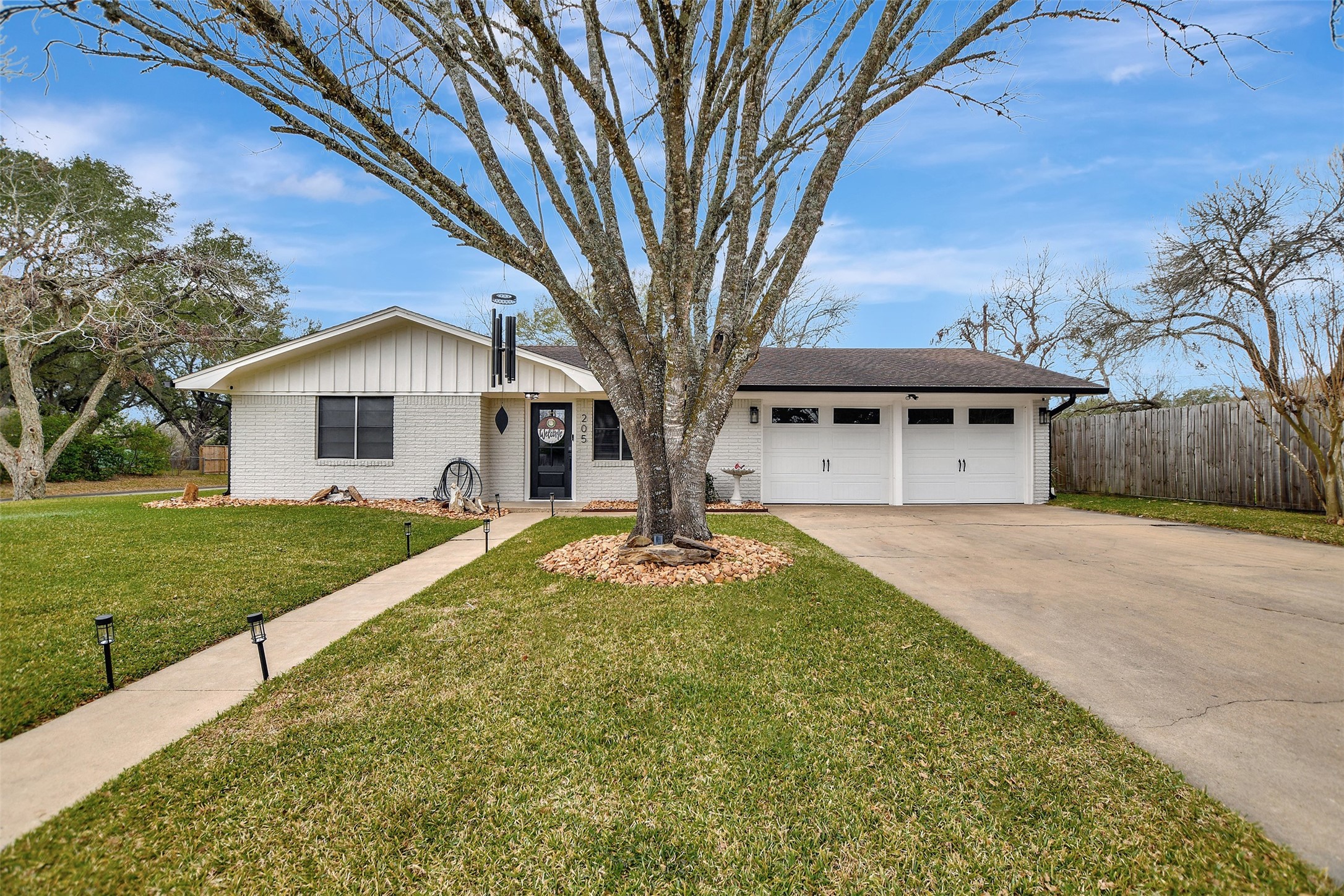 205 Munz Street Brenham, TX 77833 - Photo 2 of 48 a front view of a house with garden