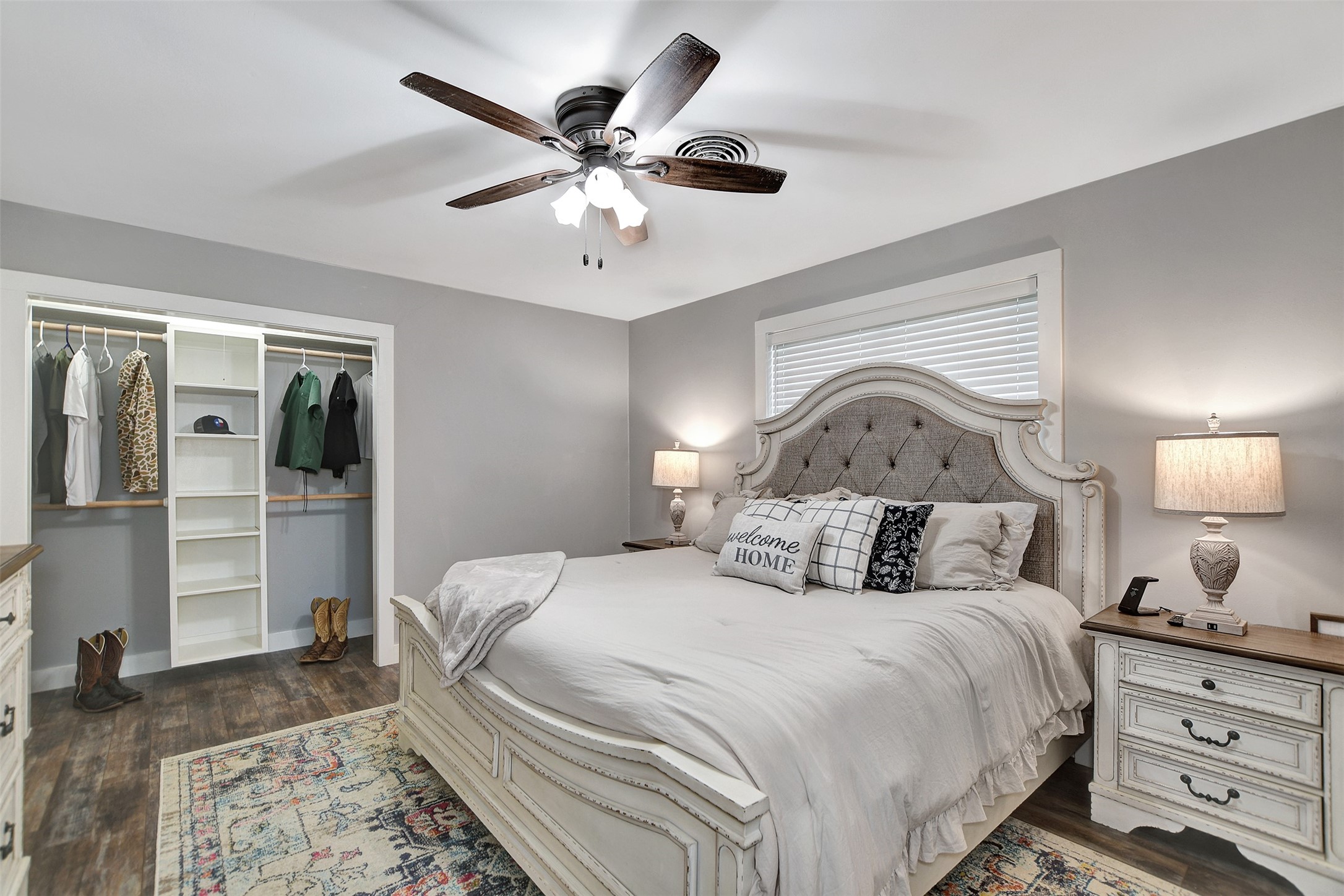 205 Munz Street Brenham, TX 77833 - Photo 21 of 48 a bedroom with a large bed and a chandelier