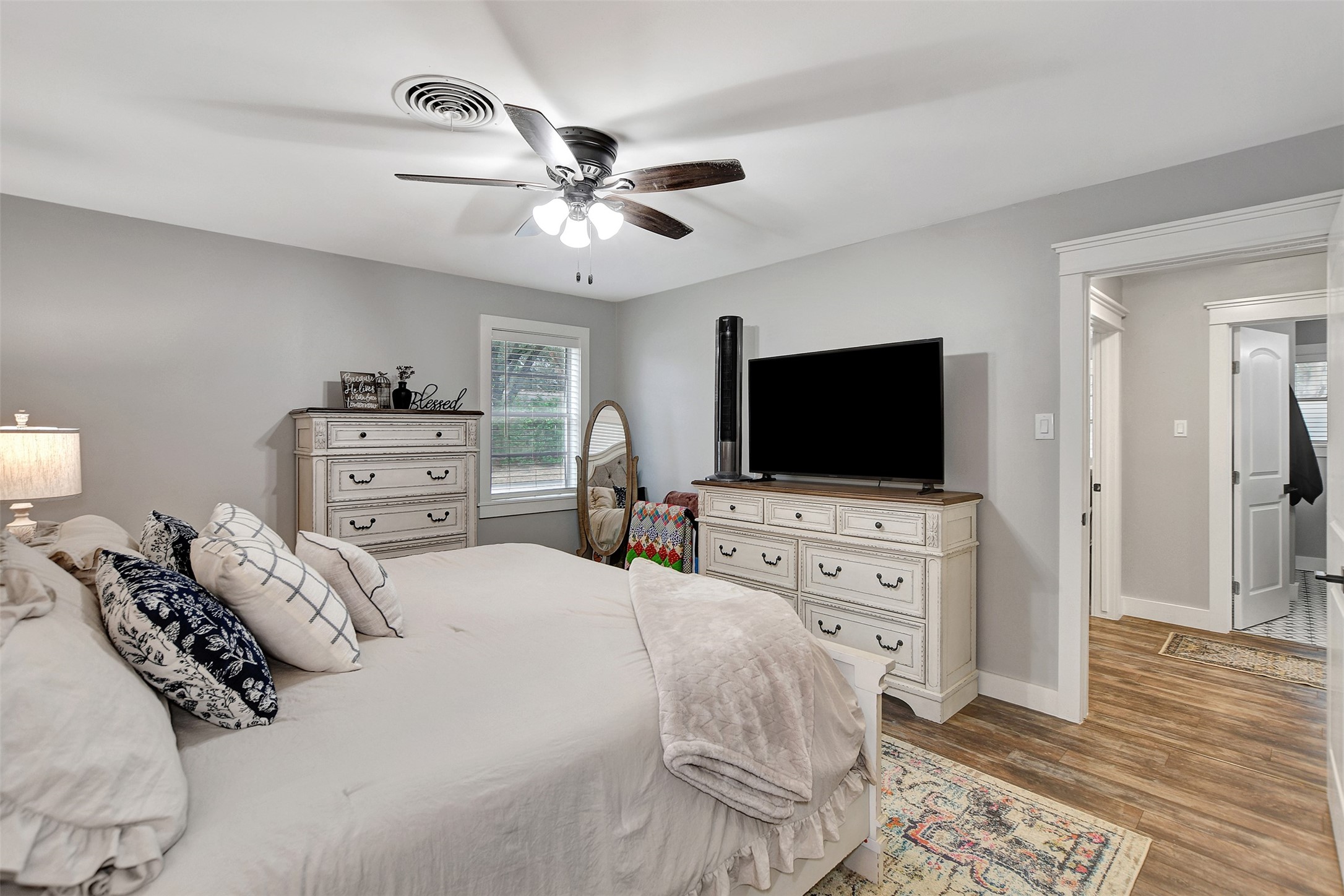 205 Munz Street Brenham, TX 77833 - Photo 22 of 48 a bedroom with a bed and a flat screen tv