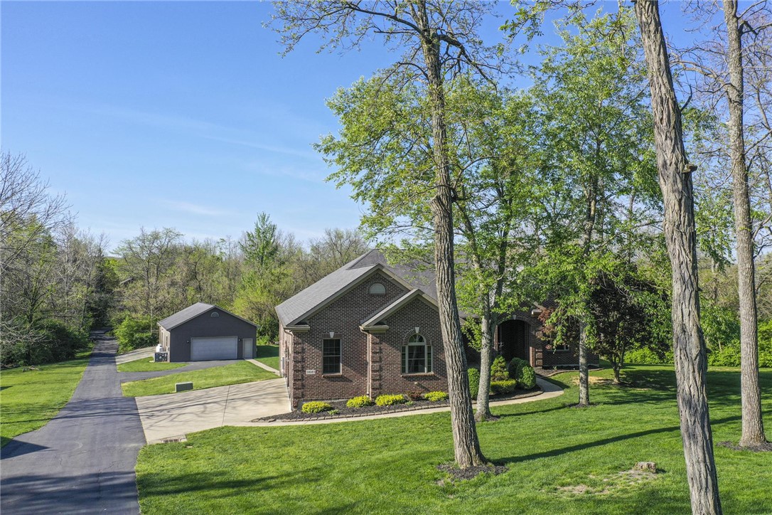 3681 Wilmington Road Lebanon, OH 45036 - Photo 5 of 87 This classic brick residence features a long paved driveway leading to a separate garage building.