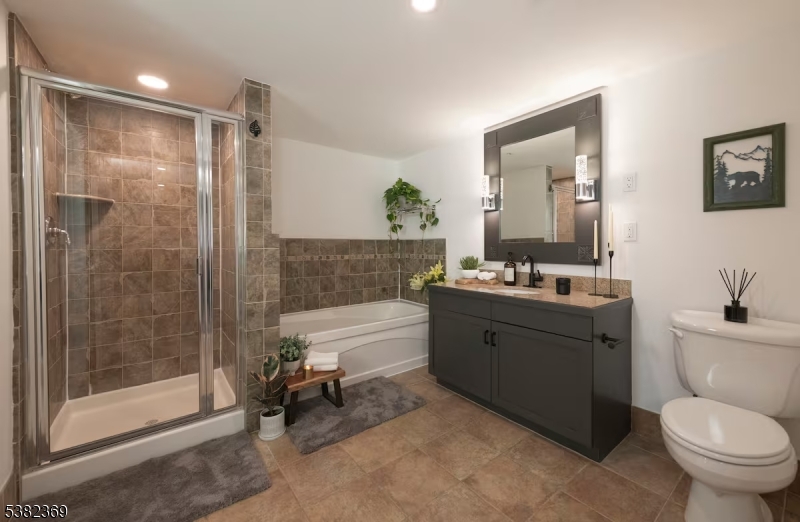 200 Highway 94 Vernon, NJ 07462 - Photo 15 of 25 a spacious bathroom with a granite countertop sink toilet a mirror and shower