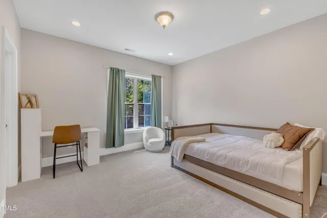 a spacious bedroom with a bed and a large window