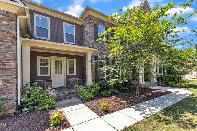 an empty room with wooden floor wooden floor and windows