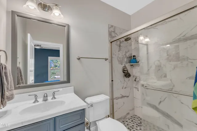 a bathroom with a glass shower door