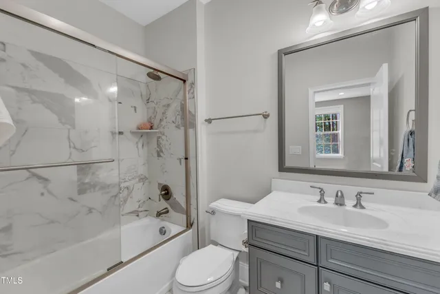 a spacious bathroom with a tub sink and mirror