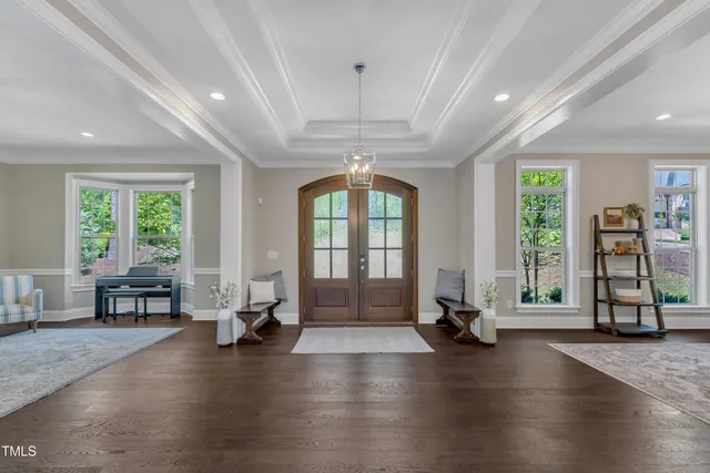 a living room with furniture and a chandelier