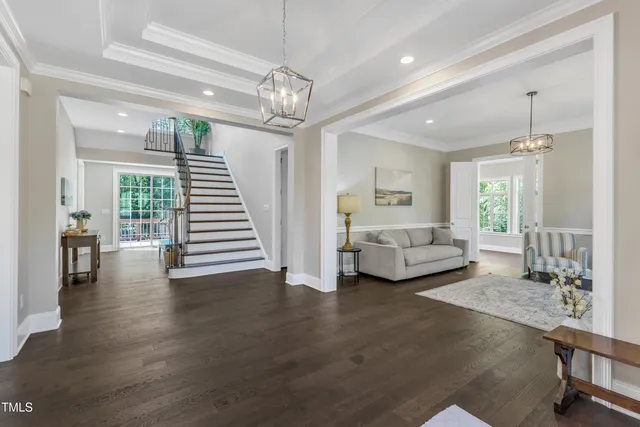 a living room with furniture and a chandelier