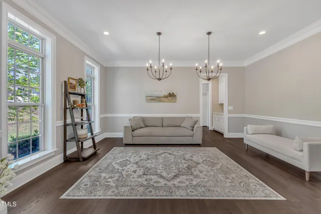 a living room with furniture a window and a table