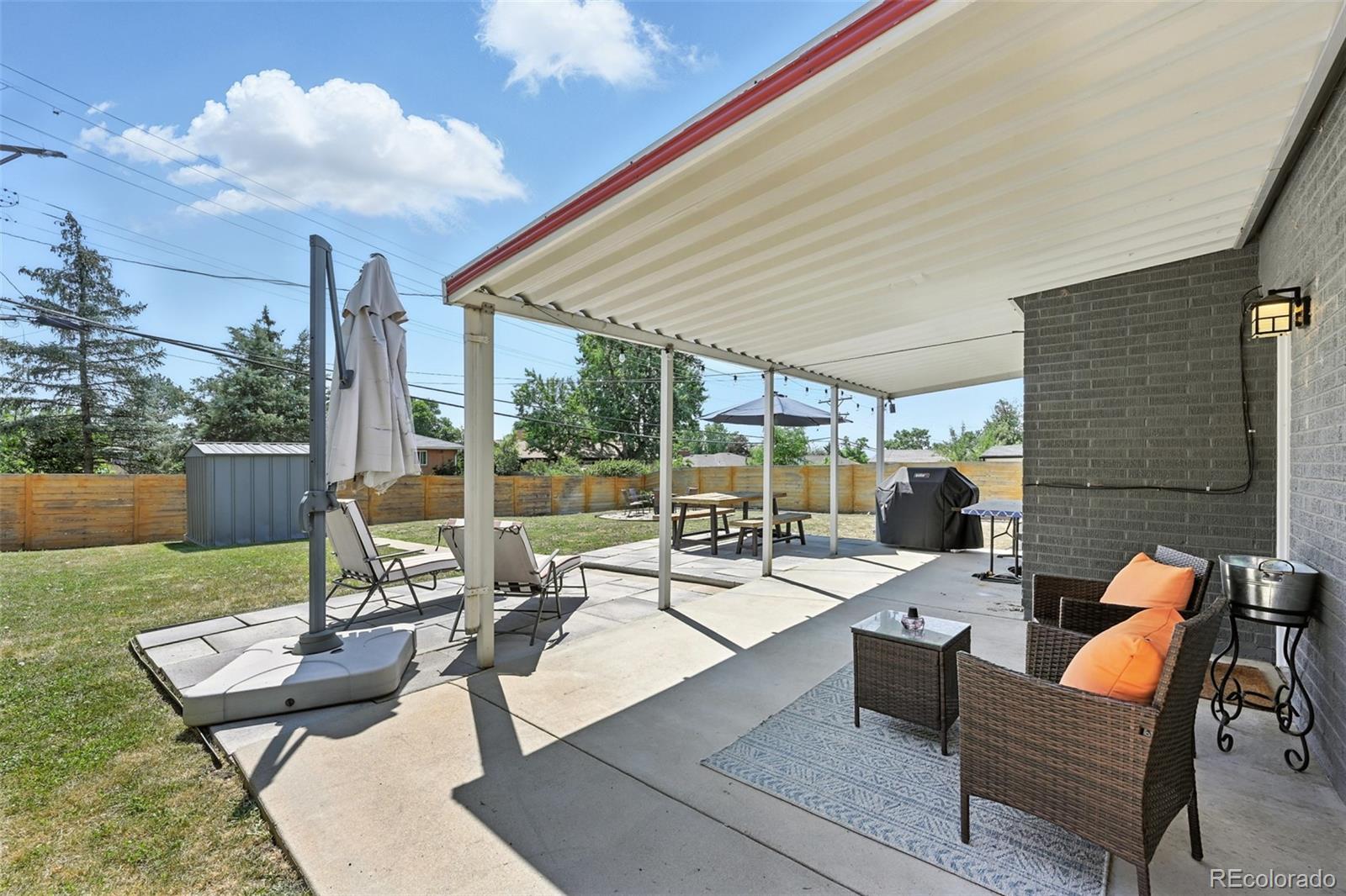2714 South Raleigh Street Denver, CO 80236 - Photo 30 of 34 a view of a patio with couches chairs dining table and chairs