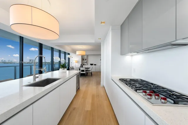 a walk in closet with lots of wooden floor