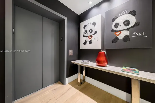 a view of entryway and hall with wooden floor