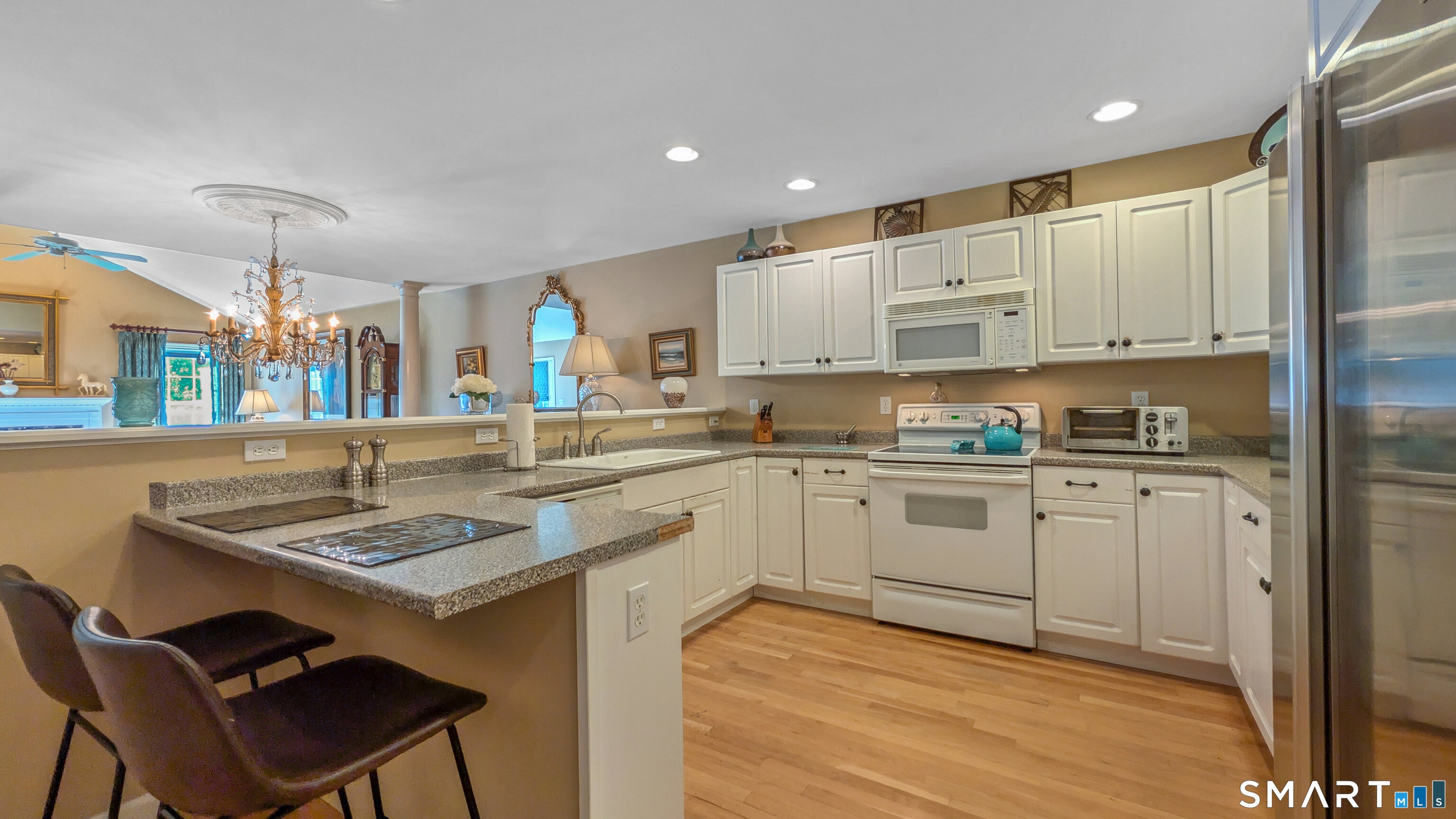 123 Louis Hill Road, Unit 123 Newtown, CT 06482 - Photo 7 of 35 a kitchen with stainless steel appliances granite countertop a stove a sink dishwasher and a refrigerator with wooden floor