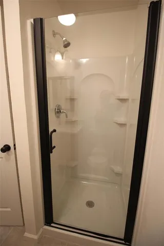 a bathroom with a glass door shower