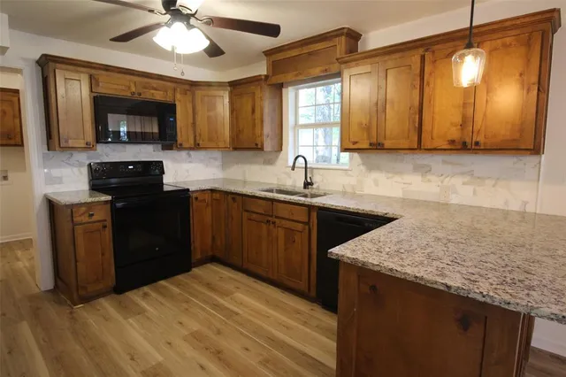 a kitchen with a sink stove and cabinets
