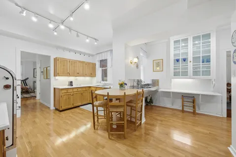 a living room with furniture a dining table and a large window