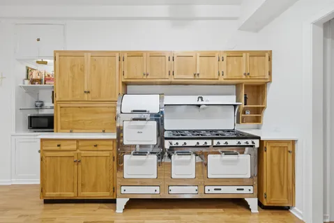 a kitchen with a stove and white cabinets