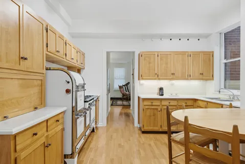 a kitchen with cabinets and wooden floor