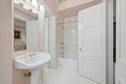a bathroom with a sink a mirror and a bathtub